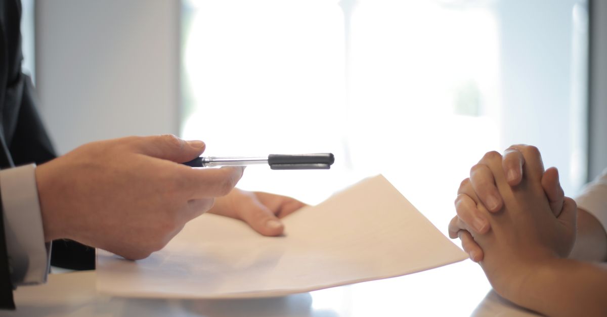Business person reviewing and signing a contract document